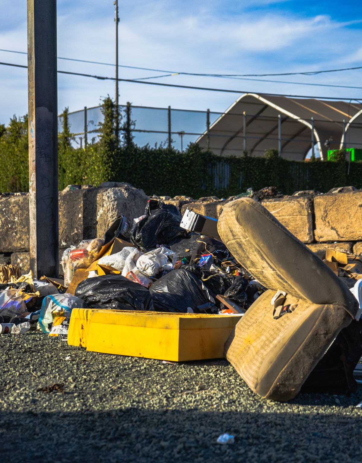 Unwanted furniture and bagged household debris ready for removal
